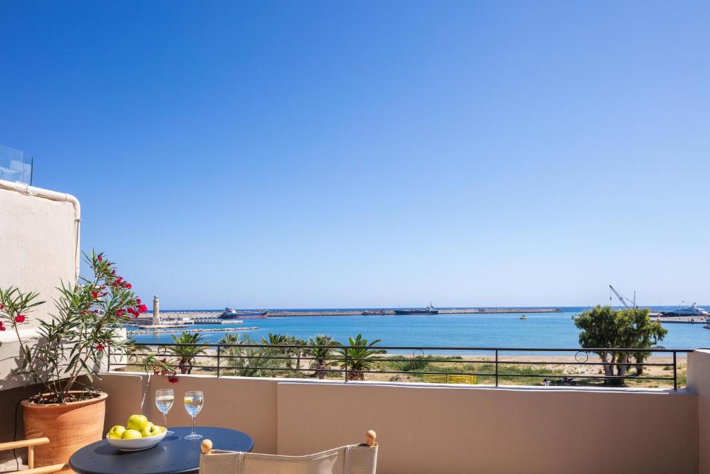 a balcony with a view of the ocean at Chryssi Seafront Living, 03 Suite, right on the beach in Rethymno! in Rethymno Town