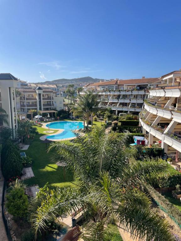 an aerial view of a resort with a pool and palm trees at Apartamento Cala de Mijas in La Cala de Mijas