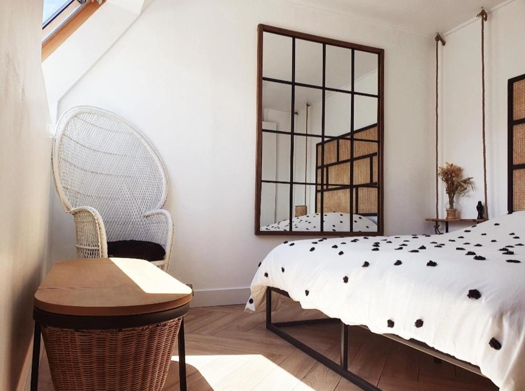 a bedroom with a bed and a chair and a window at Love Room Charnelle, Chic, Hammam, Clim in Chartres