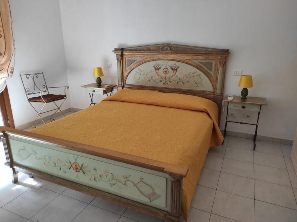 a bedroom with a large bed and two night stands at Casa Marina in Sestu