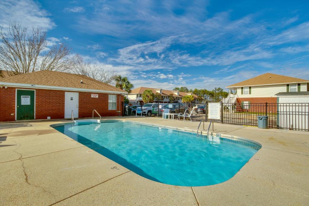 a swimming pool in a yard with a house at Birding, Beaches and More Cozy Gautier Condo in Gautier