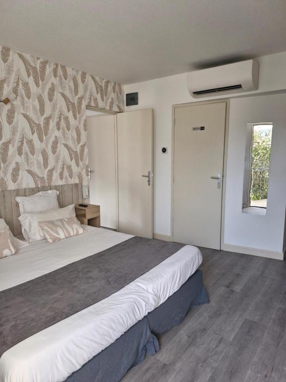 Postel nebo postele na pokoji v ubytování Hotel Le Vanséen
