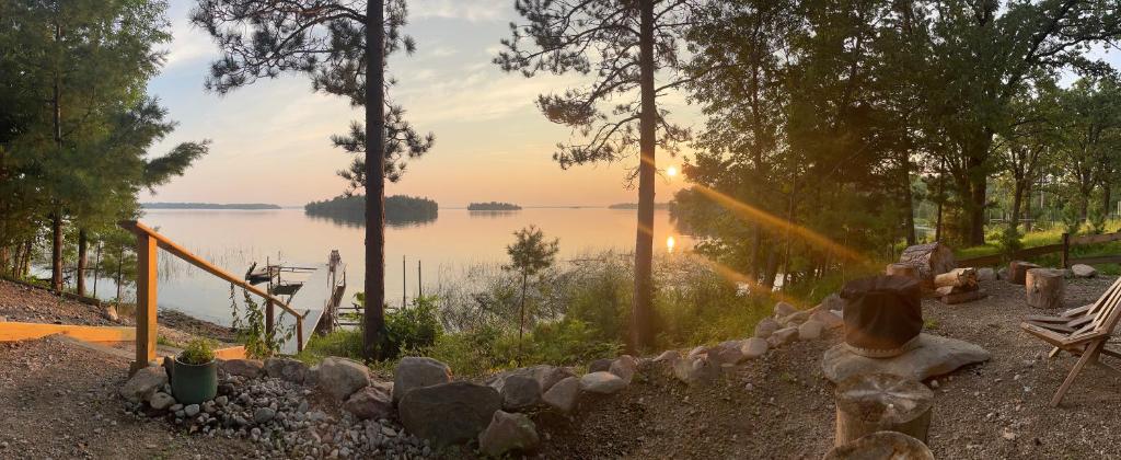 a view of a body of water with the sun setting at Gorgeous Views, Fishing at Private Cabin on Pelican Lake, Orr MN in Orr