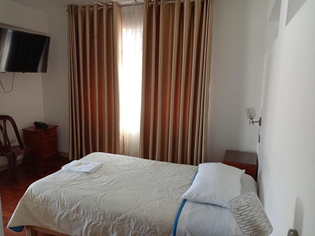 Postel nebo postele na pokoji v ubytování Hostal Bond