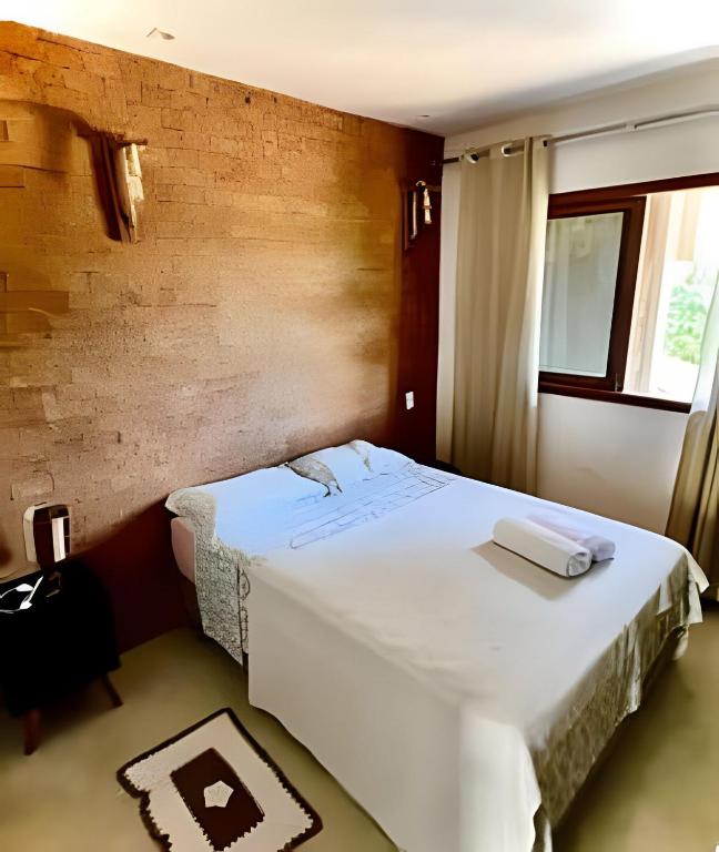 En eller flere senge i et værelse på Apto Sossego - Barbosa acomodações