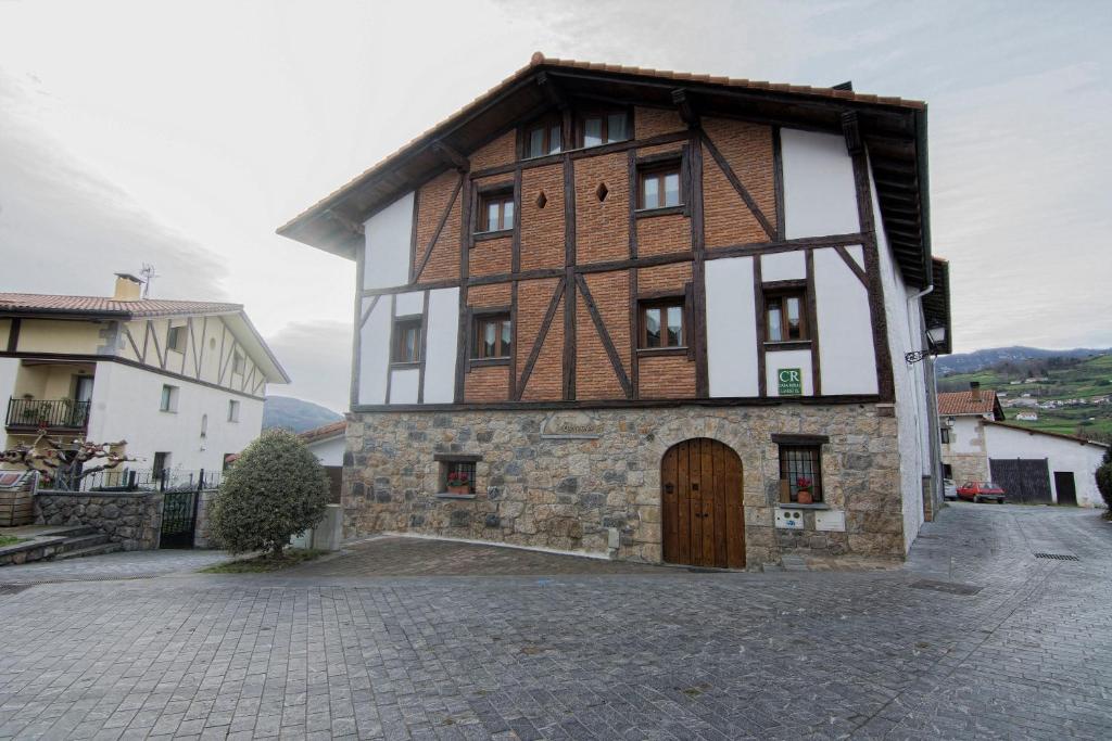 a large building with a wooden door on a street at Zumargain in Asteasu