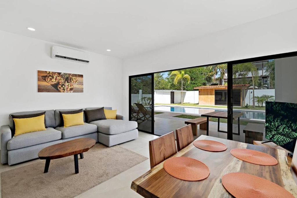 a living room with a couch and a table at Casa Corales Dreams 1 in Playa Flamingo