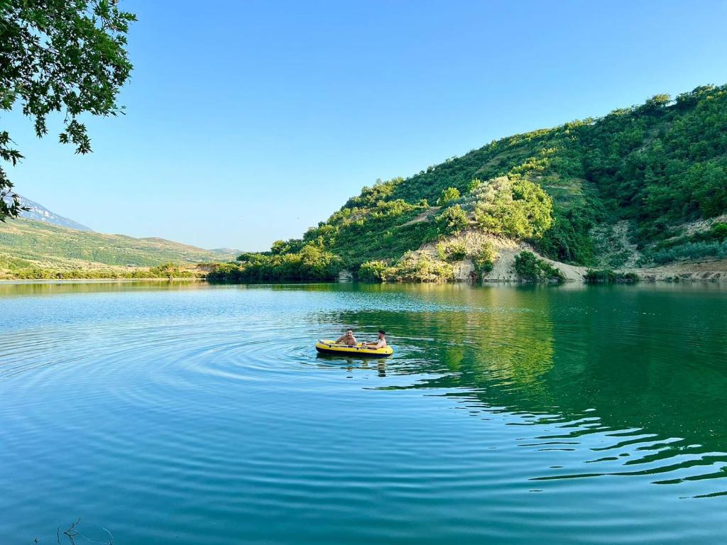 two people in a boat on a lake at Alpeta Agrotourism & Winery - Roshnik , Berat in Berat