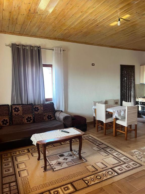 a living room with a couch and a table at Bert-House close to the sea in Lezhë