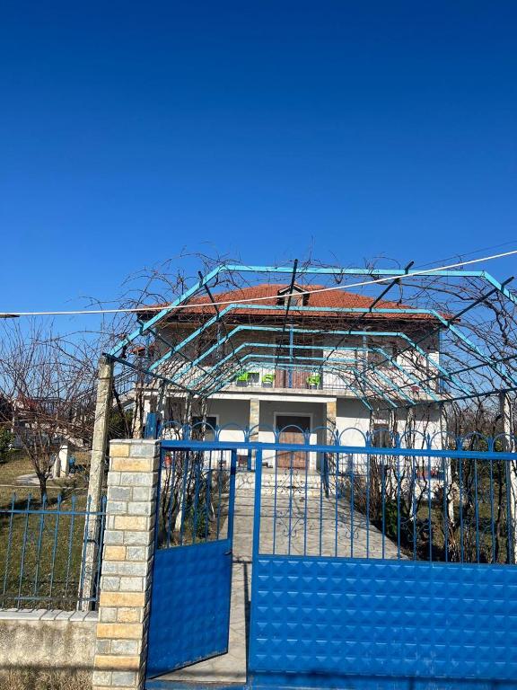 a building with a gate in front of it at Bert-House close to the sea in Lezhë