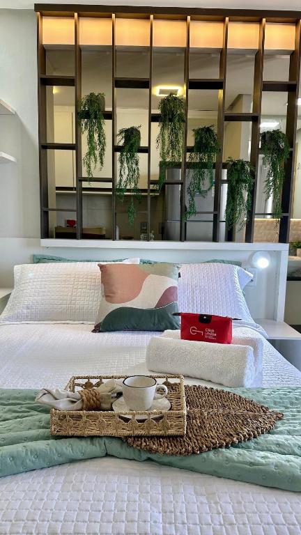 a bed with a tray of food on it at (1406) Elegant Studio with Sea View in Vinhais