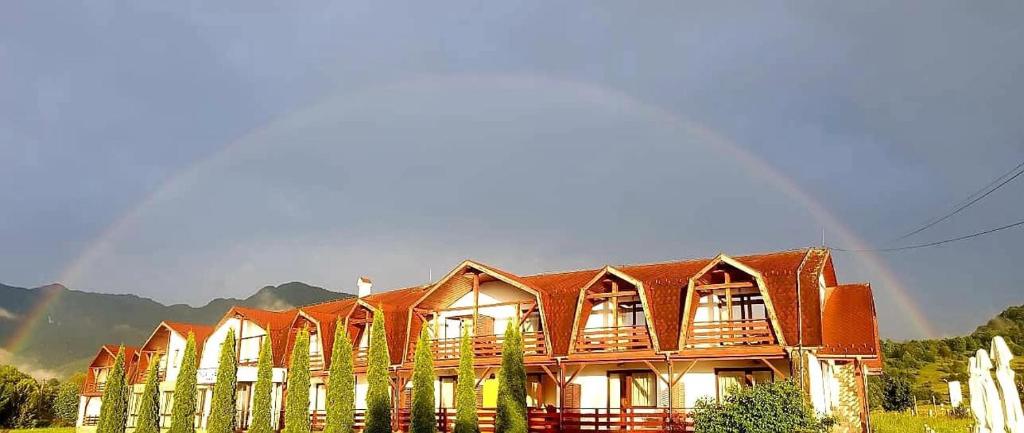 a large building with a red roof at Conca Verde Râșnov in Râşnov