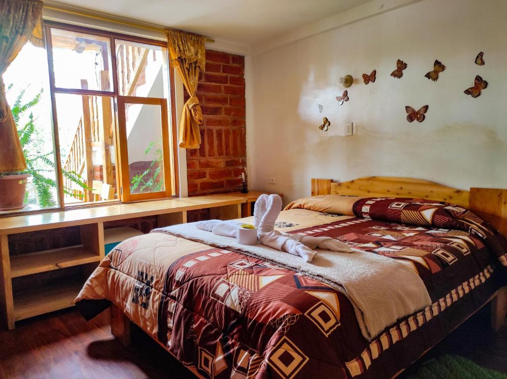 Postel nebo postele na pokoji v ubytování Hostal Cloud Forest