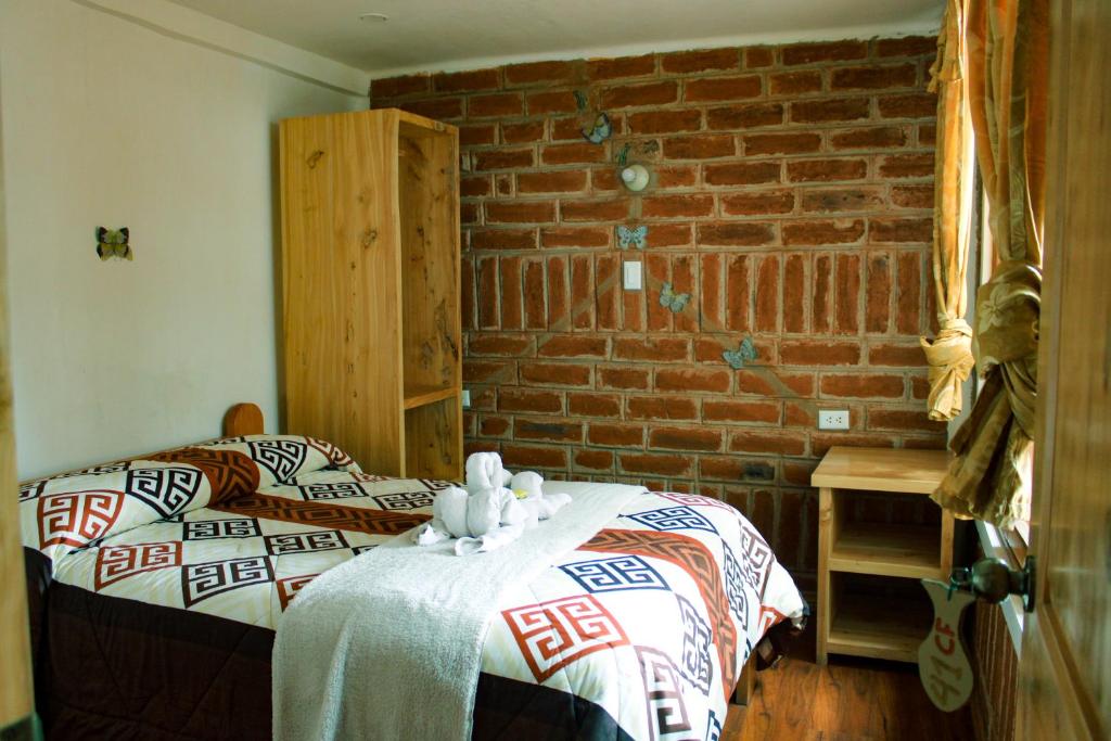 Postel nebo postele na pokoji v ubytování Hostal Cloud Forest