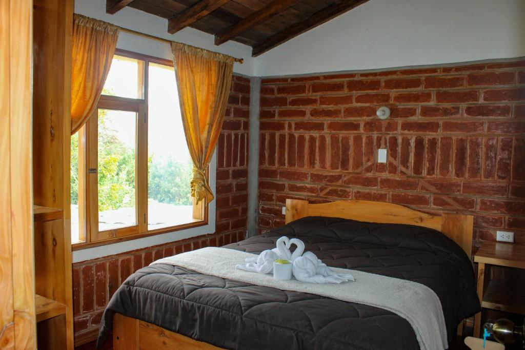 Postel nebo postele na pokoji v ubytování Hostal Cloud Forest