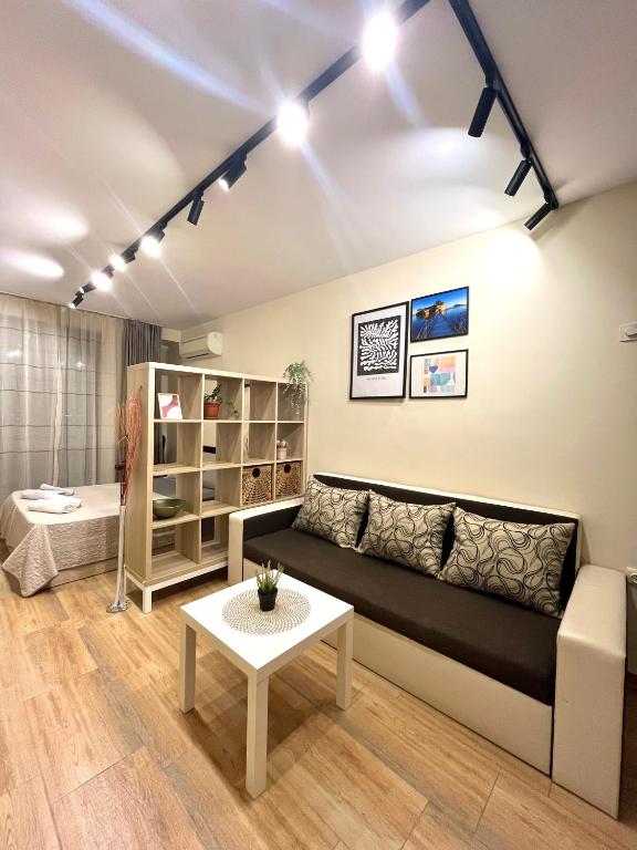 a living room with a couch and a table at Salt Lake Studio in Pomorie