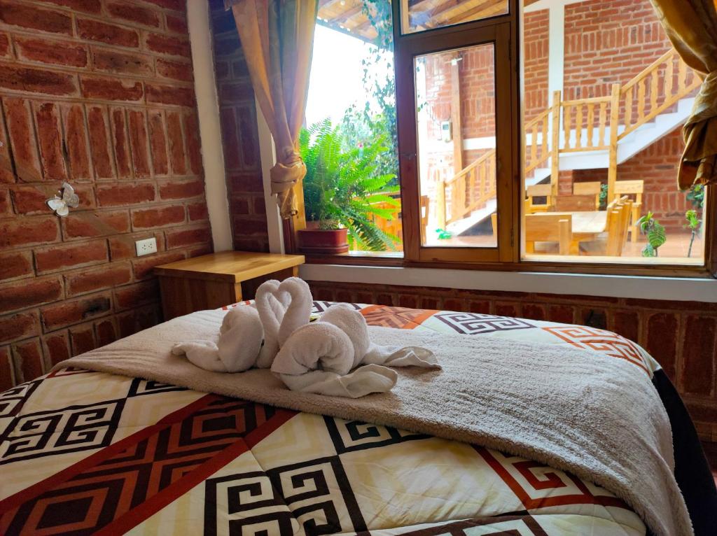 Postel nebo postele na pokoji v ubytování Hostal Cloud Forest
