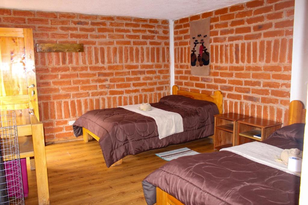 Postel nebo postele na pokoji v ubytování Hostal Cloud Forest