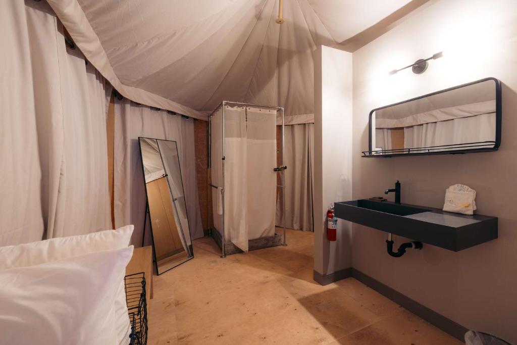 a bathroom with a sink and a shower in a tent at Zion Wildflower Resort in Virgin