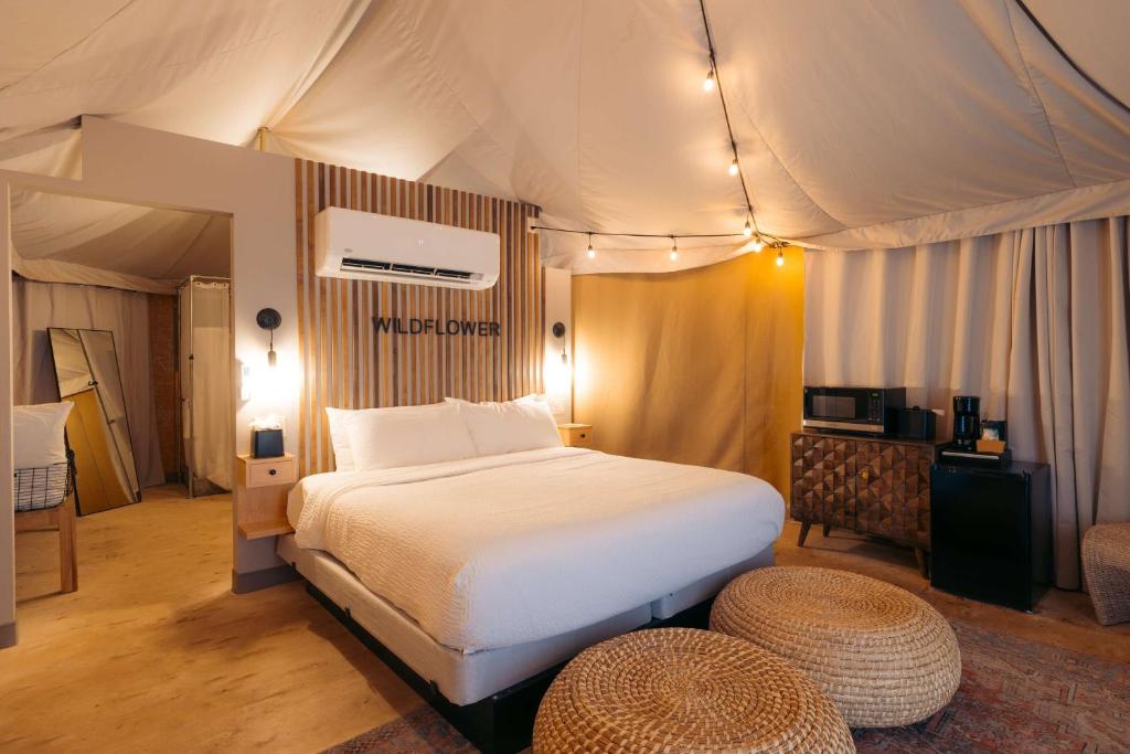 a bedroom with a bed in a tent at Zion Wildflower Resort in Virgin