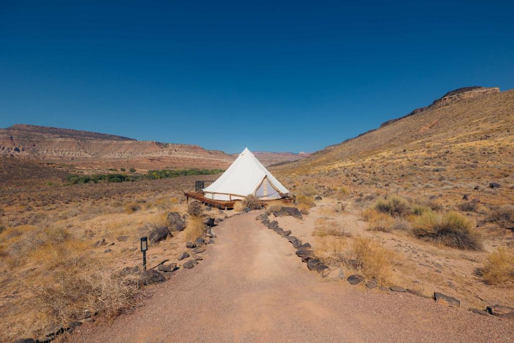 a tent on a dirt road in the desert at Zion Wildflower Resort in Virgin