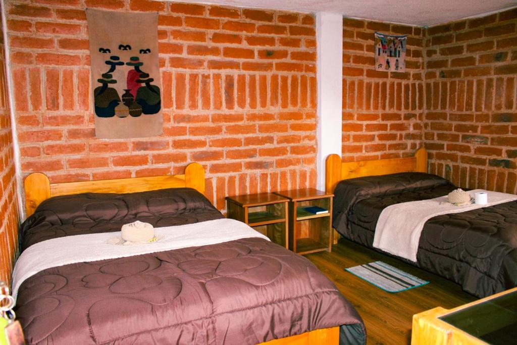 Postel nebo postele na pokoji v ubytování Hostal Cloud Forest