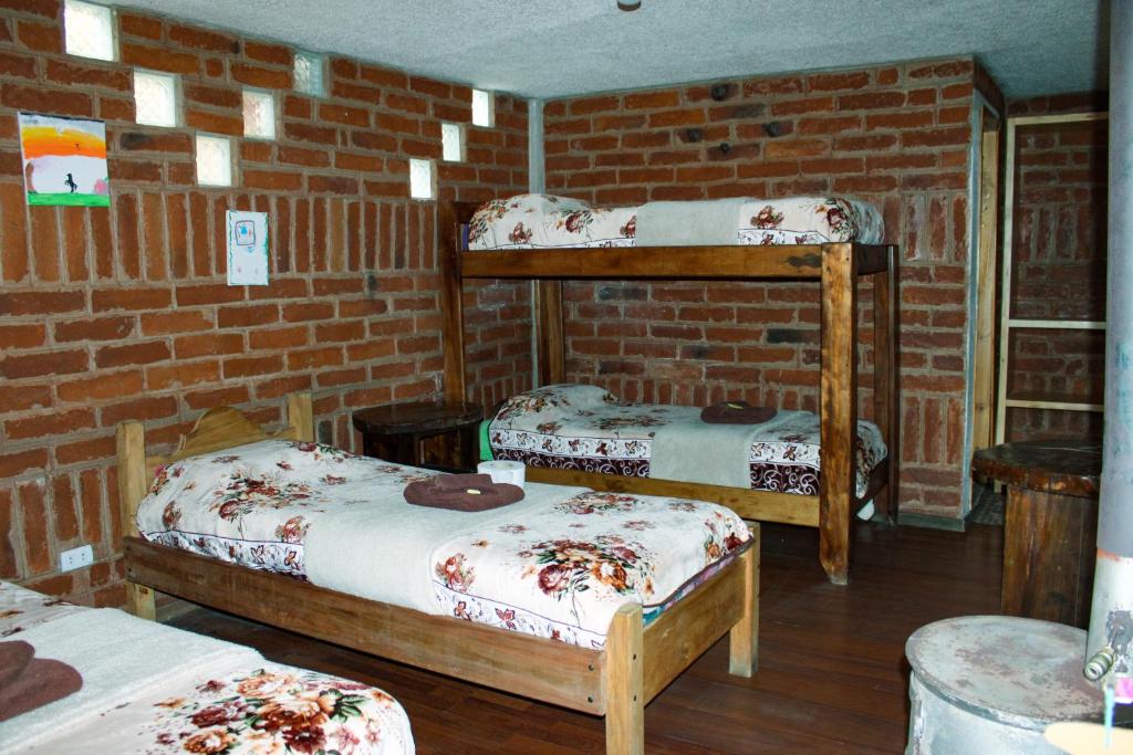 Postel nebo postele na pokoji v ubytování Hostal Cloud Forest