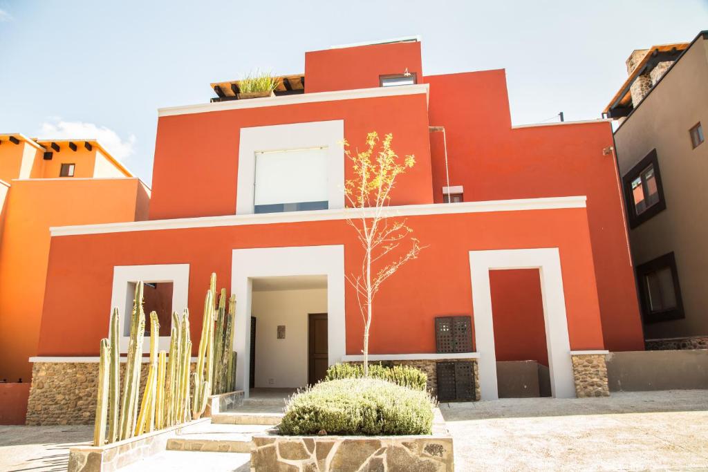 a red house with cactus in front of it at Villa Lavanda in San Miguel de Allende
