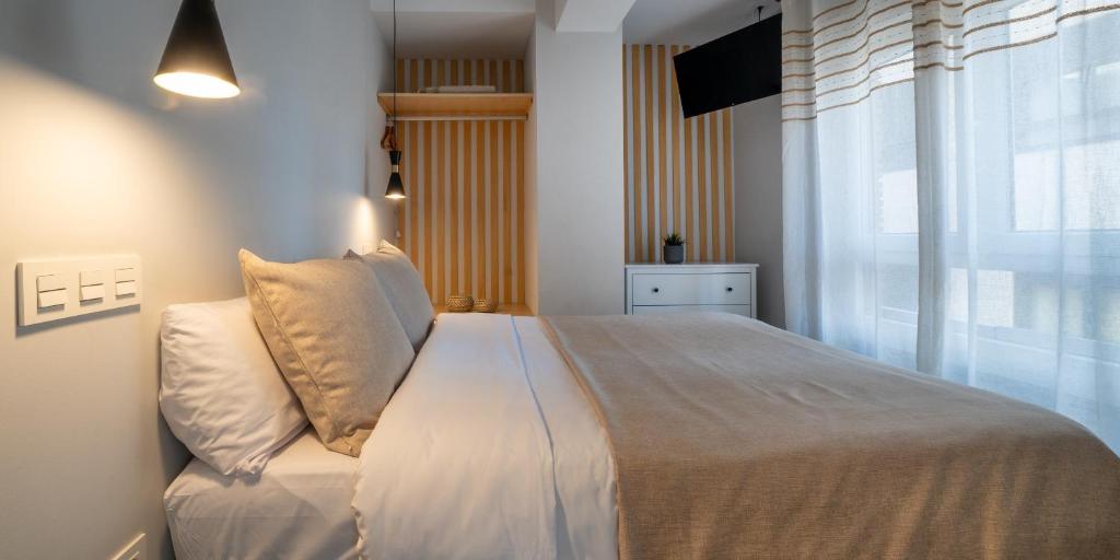 Posteľ alebo postele v izbe v ubytovaní Apartamentos Aranda - La Cepa I - II
