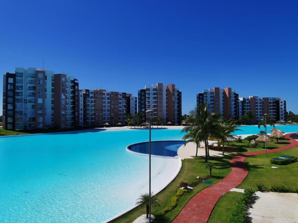 a large swimming pool in front of a city at Dreams Lagoon in Cancún