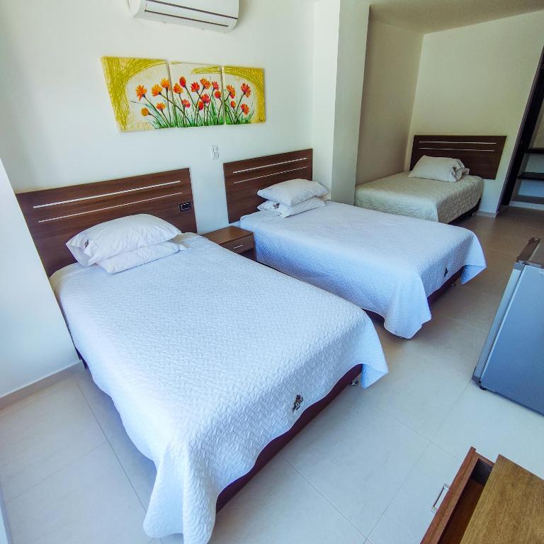 Postel nebo postele na pokoji v ubytování Hotel Suma Wasi