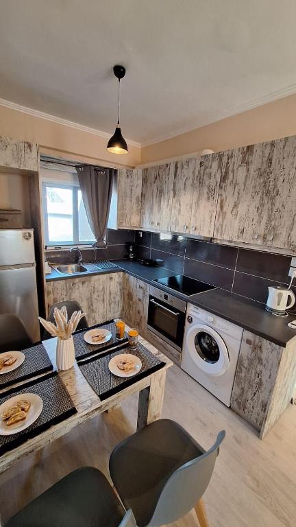 a kitchen with a table with plates of food on it at Nylio Apartment in Preveza