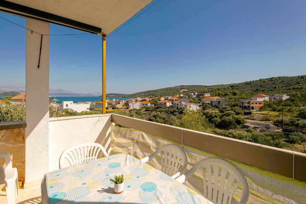 a table and chairs on a balcony with a view at Apartments Naki in Slatine