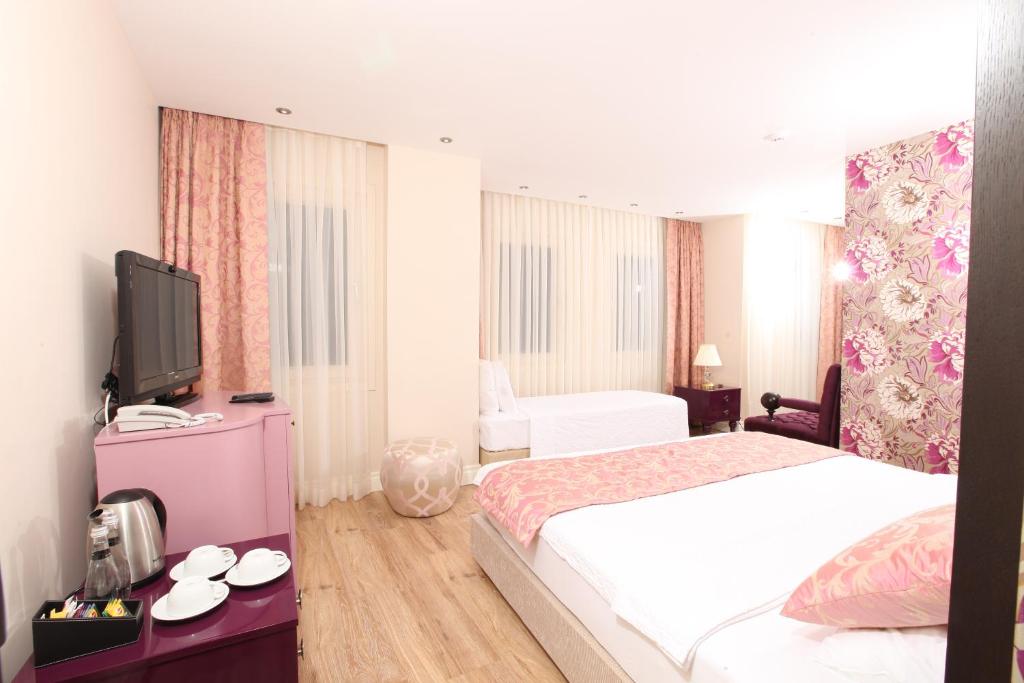 Postel nebo postele na pokoji v ubytování Katelya Hotel