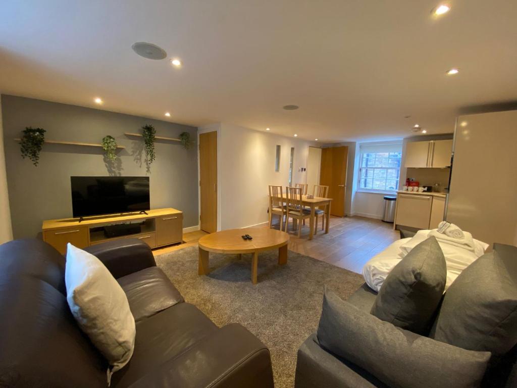a living room with a couch and a table at CS Exclusive Apartments of Princess Street West End in Edinburgh