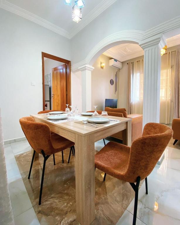 a dining room with a table and chairs at Luma in Yaoundé
