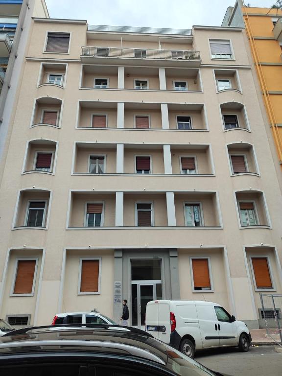 a white van parked in front of a building at Room and Suite - BARI CENTRALE - in Bari