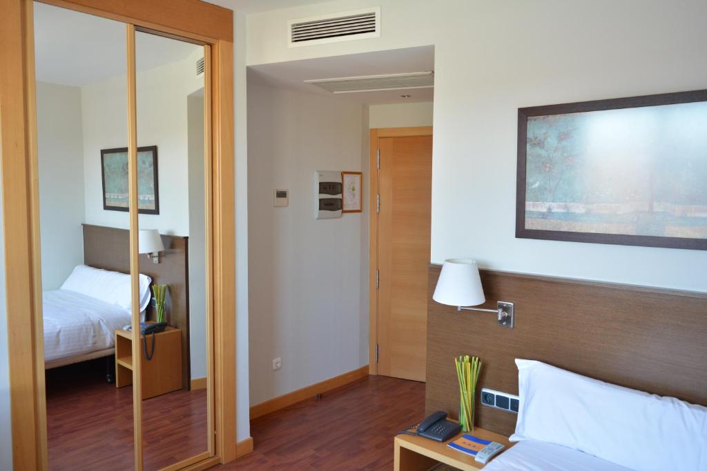 Postel nebo postele na pokoji v ubytování Hotel Palacio Congresos