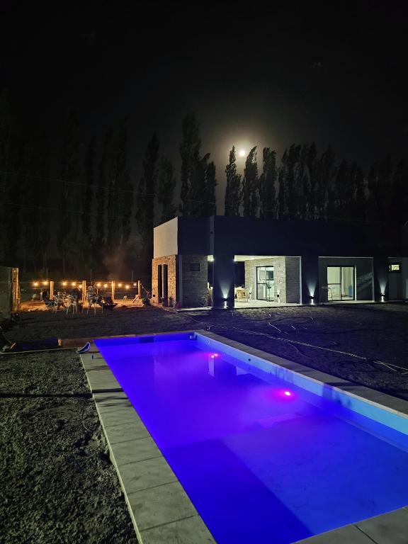 a swimming pool in front of a building at night at Elysium de Uco in Tupungato