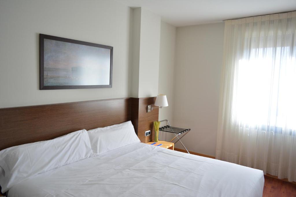 Postel nebo postele na pokoji v ubytování Hotel Palacio Congresos