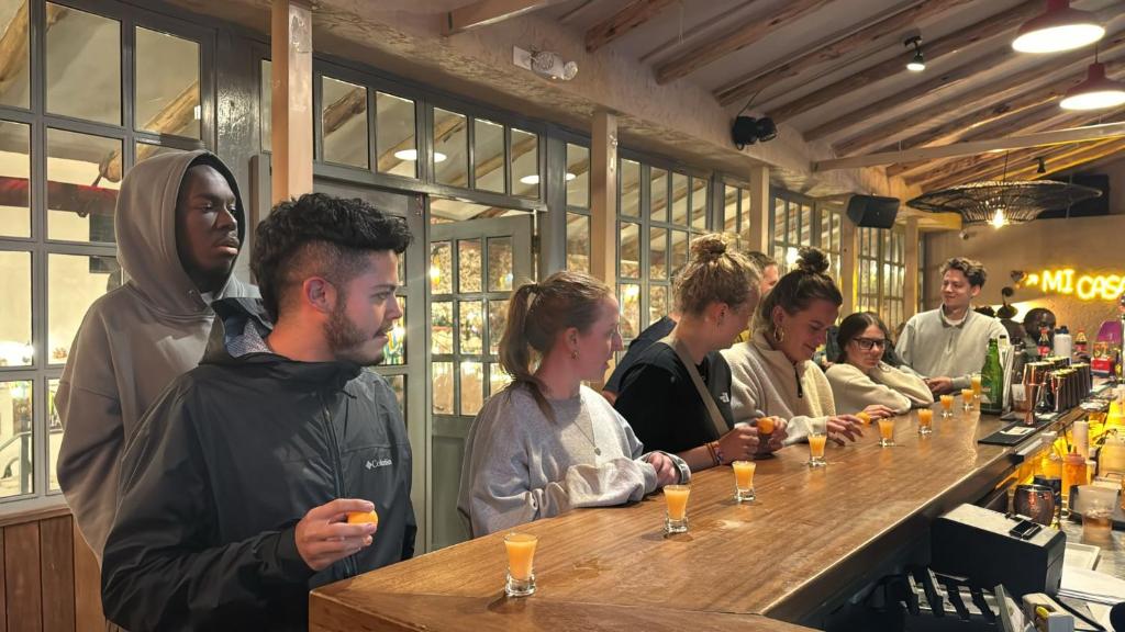 a group of people standing at a bar at Viajero Cusco Hostel in Cusco
