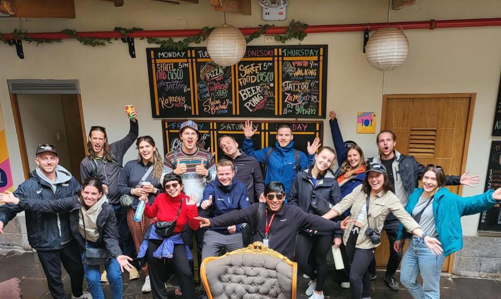 a group of people posing for a picture with a bed at Viajero Cusco Hostel in Cusco
