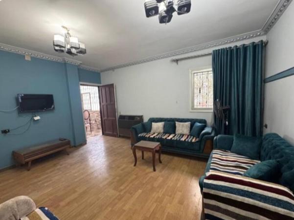 a living room with a couch and a tv at The GEM Star House in Cairo