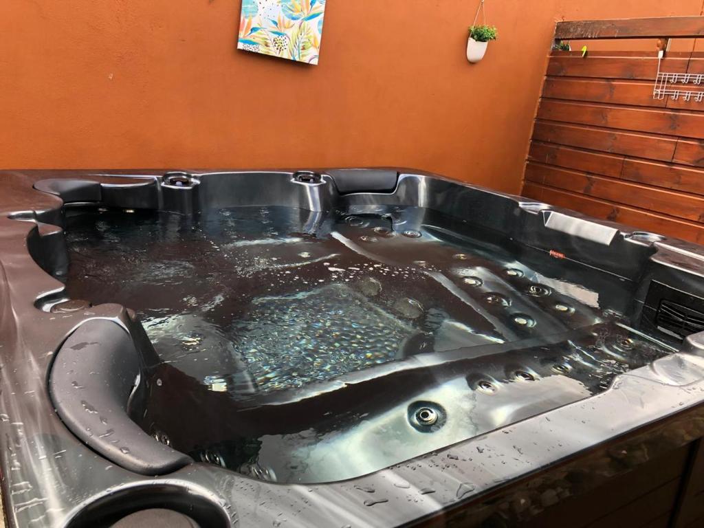 a large hot tub in a bathroom with a toilet at PASSION de PARADIS in Rivière-Pilote