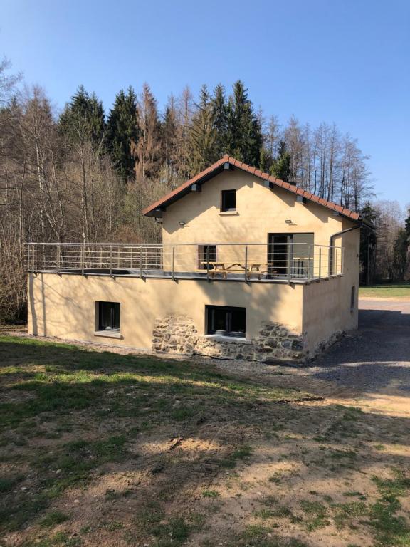 a house that is sitting in a field at La Ruine Single-family House with Hot Tub in Laveline