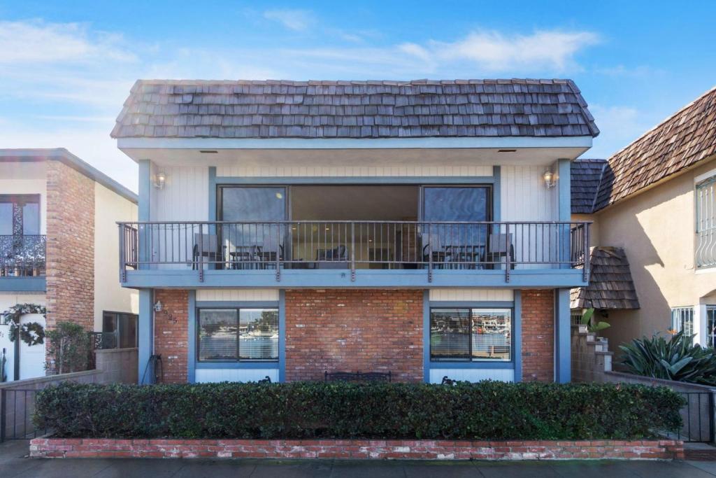 a large house with a balcony with chairs on it at 925 W Bay Ave in Newport Beach