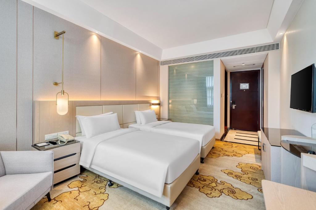 Postel nebo postele na pokoji v ubytování Dayhello Hotel Shenzhen Shekou