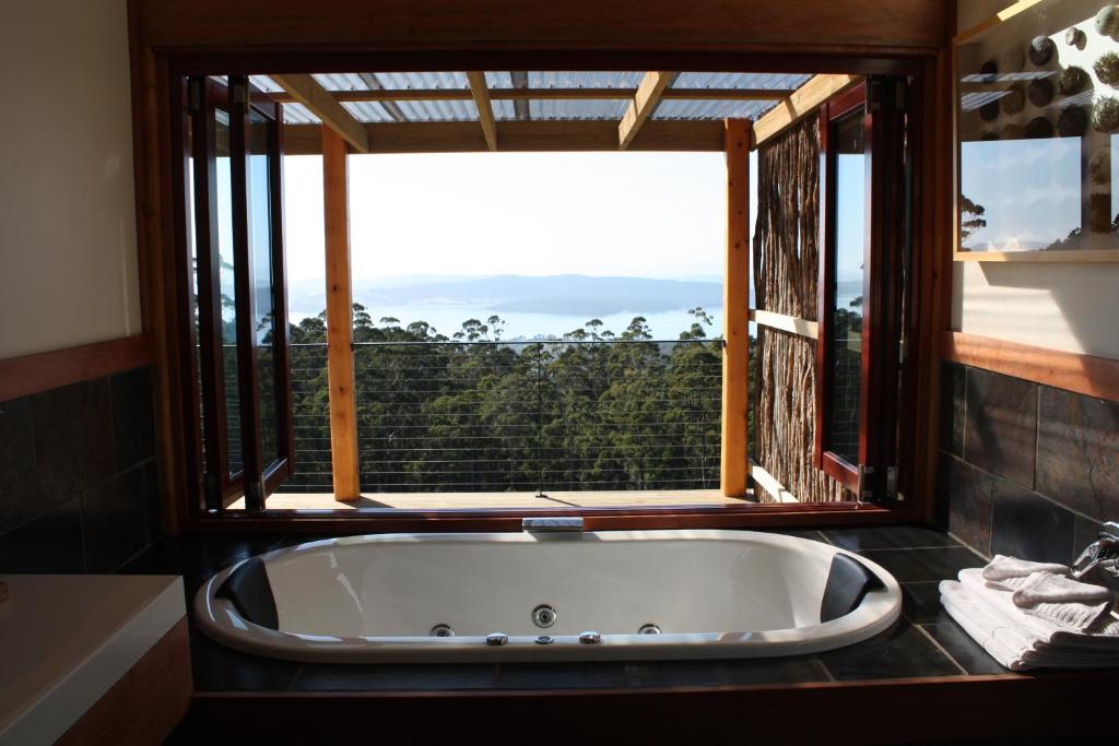 a bath tub in a bathroom with a window at Woodbridge Hill Hideaway in Woodbridge