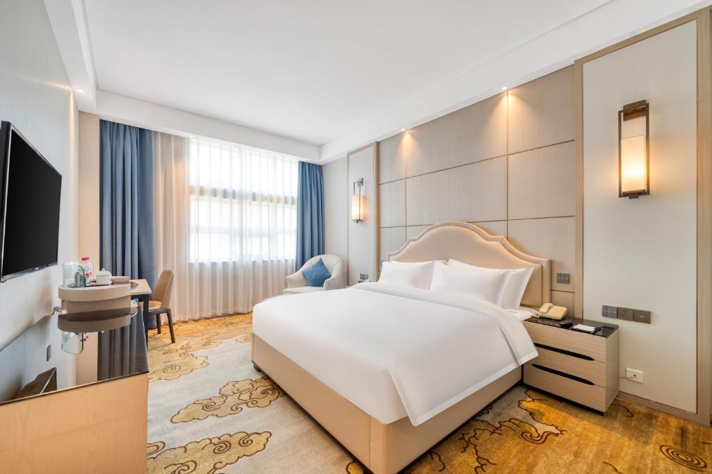 Postel nebo postele na pokoji v ubytování Dayhello Hotel Shenzhen Shekou