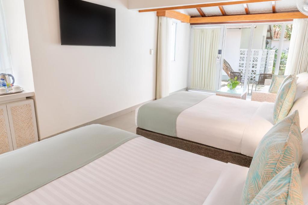 Postel nebo postele na pokoji v ubytování Hotel Irotama Bungalows & Bohios
